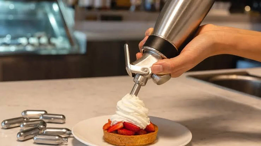 Whipped cream dispenser adding a fresh cream topping to a strawberry dessert